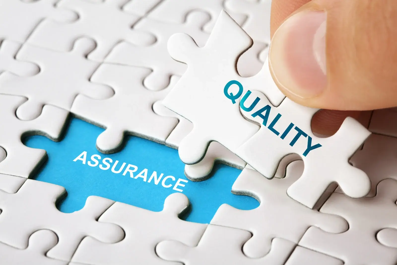 Puzzle pieces saying quality assurance